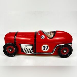 Silver Crane Company red race car storage tin, number 09, with rotating wheels